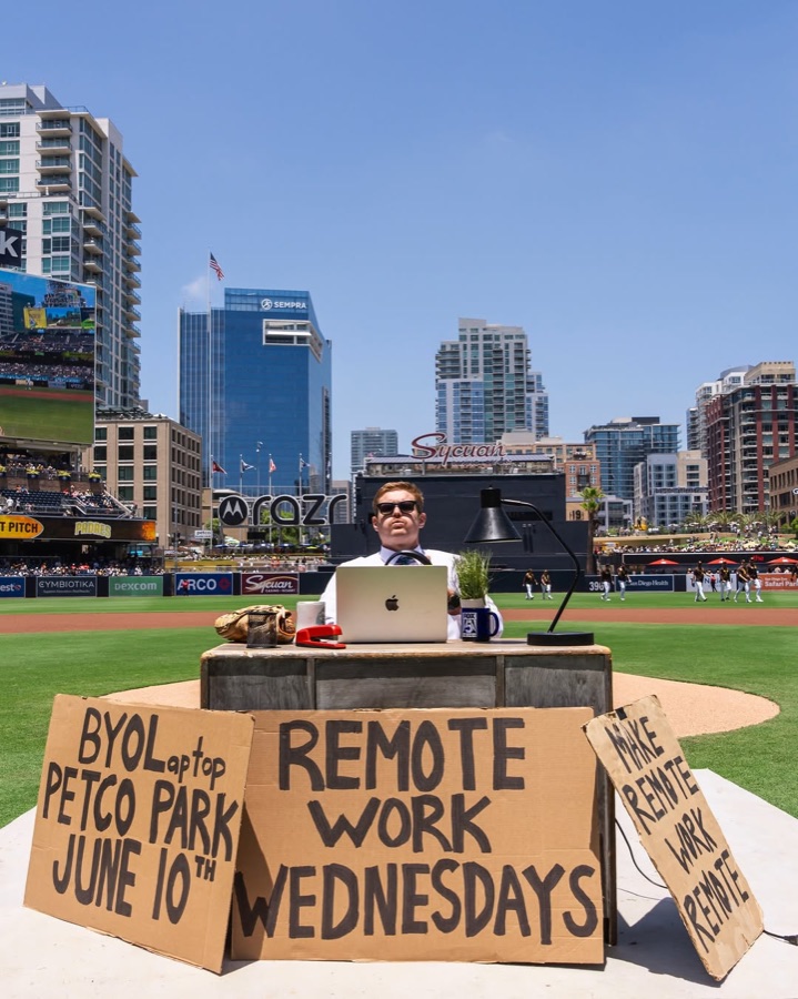 Scotty celebrating at his desk on the field at Petco Park